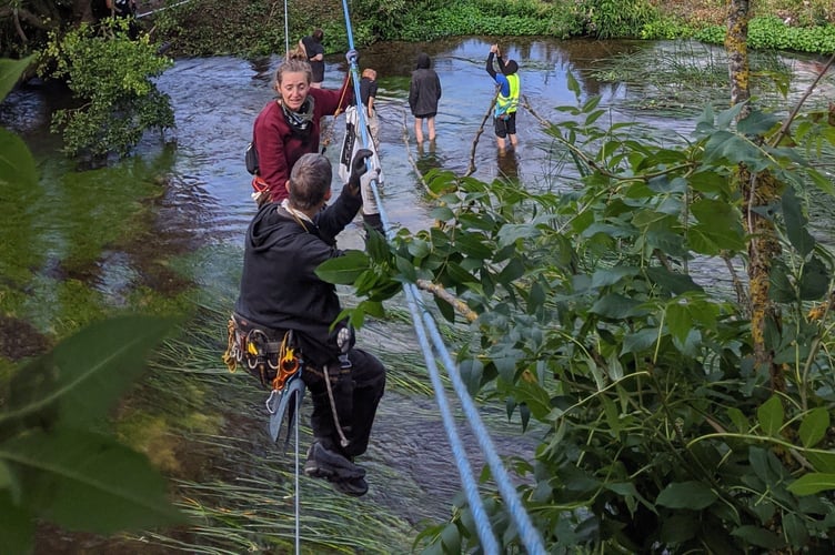 Dr Larch Maxey suspended above the River Colne Ford