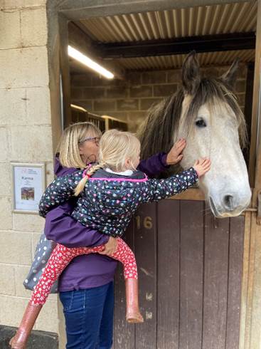 Alice and her grandmother meeting rescued horse Karma at Coombe Park