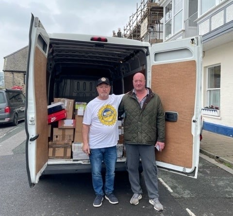 Darren Hopley, Dartmouth Yacht Club Manager, helping Mark Paine, from the Ukraine Sunflower Aid charity, load boxes onto his van ready to be taken into Ukraine