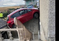 Rescue operation after car left hanging precariously over courtyard