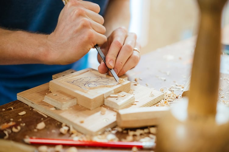 Student carving a decorative leaf.