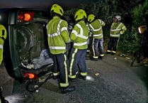 Driver ‘in good spirits’ after car ends up on its side in crash