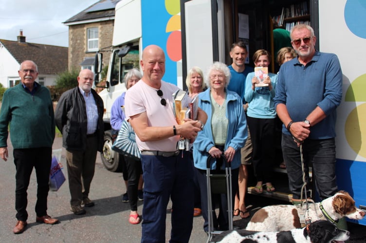 Some of those who chose and returned books from the mobile library in the square at Coldridge, with John Smith, left, in September. SR 8789