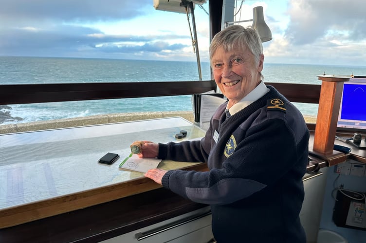 Helen an NCI Station Manager stamping the Coast Path Passport