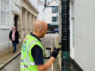 Neil paints bollard protecting special building in Totnes