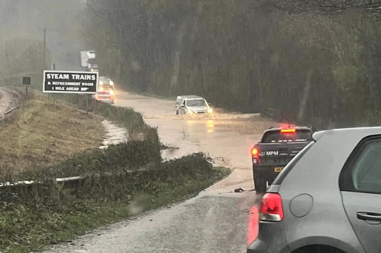 Cars waded through a flooded road between Dartington and Buckfastleigh at the weekend