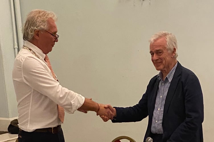 Salcombe Mayor Mark Goodey (L) presents the Chair of Salcombe Maritime Museum Roger Barrett (R) with Salcombe Citizen of the Year Award 
