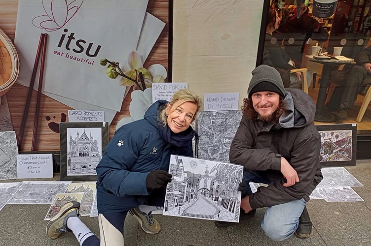 David Furler posing with Katie Hopkins and the print he sold her, depicting Totnes