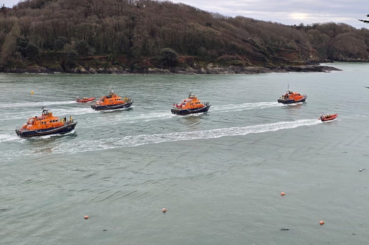 The Richard Cox Scott lifeboat heads out of the estuary with escort