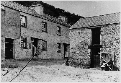 Post office at Hallsands, villagers in doorways and children watching.  Pre 1903