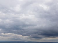 Partly cloudy with a breeze and slight chance of rain