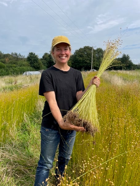 Zoe Gilbertson with harvested flax plant
