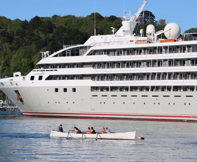 Rowers pass by 'Le Lyrial' cruise ship in the Dart 