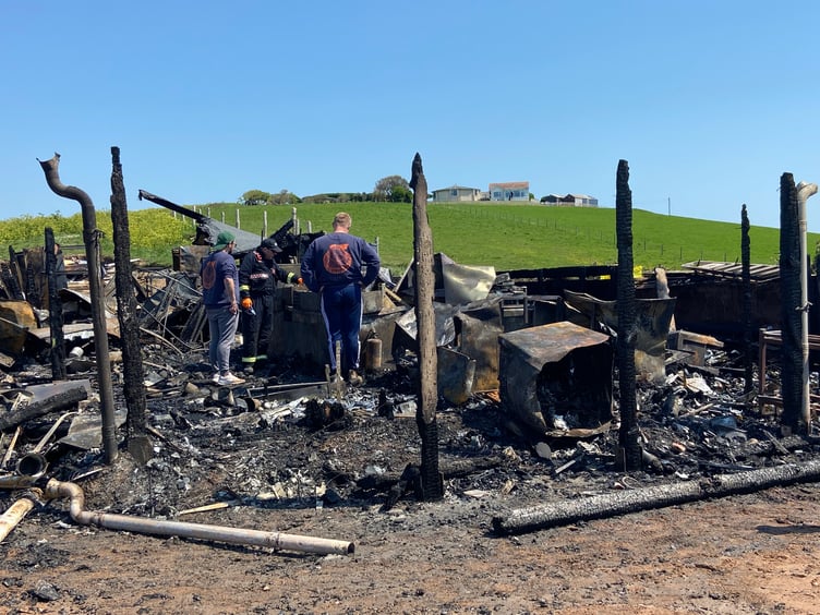 Beach House restaurant workers stood amongst the wreckage following the fire in May.