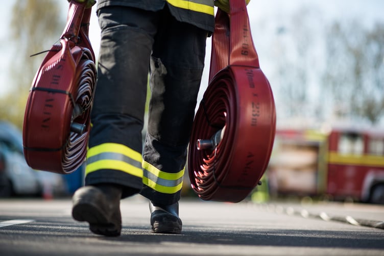 Devon and Somerset Fire and Rescue Services carrying hoses