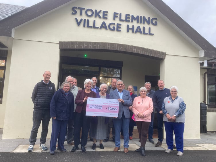 Caroline Voaden MP presents the cheque to villagers