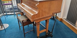 Watermark giving away baby grand piano 