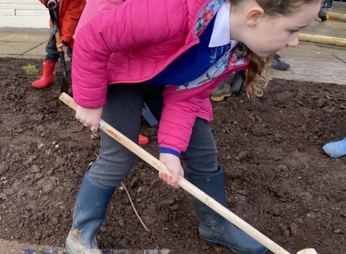 Early Years pupils play in the new dig pit at Salcombe C of E Primary School.